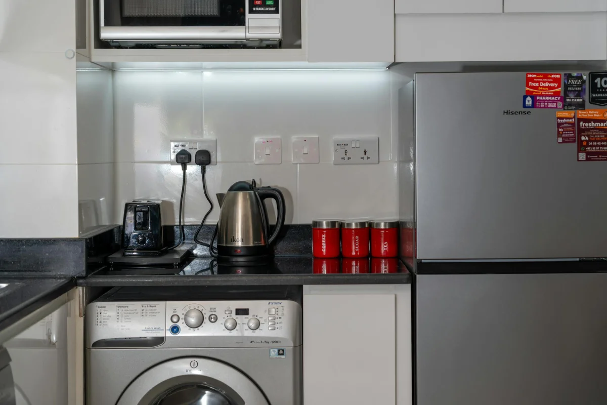 A modern kitchen featuring energy-intensive devices to identify the top household energy consuming appliances like refrigerators, dishwashers, and electric ovens.