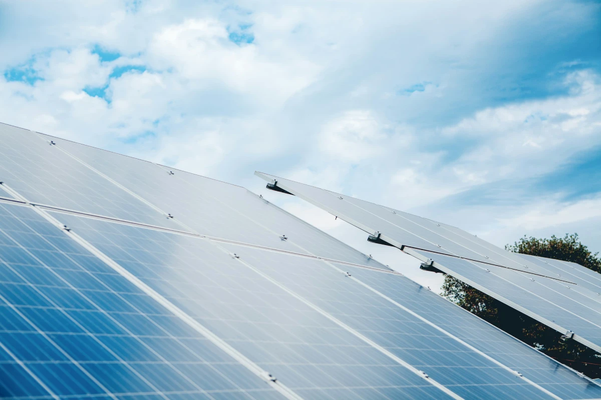 Rows of solar panels generating renewable electricity for long-term energy savings calculations.