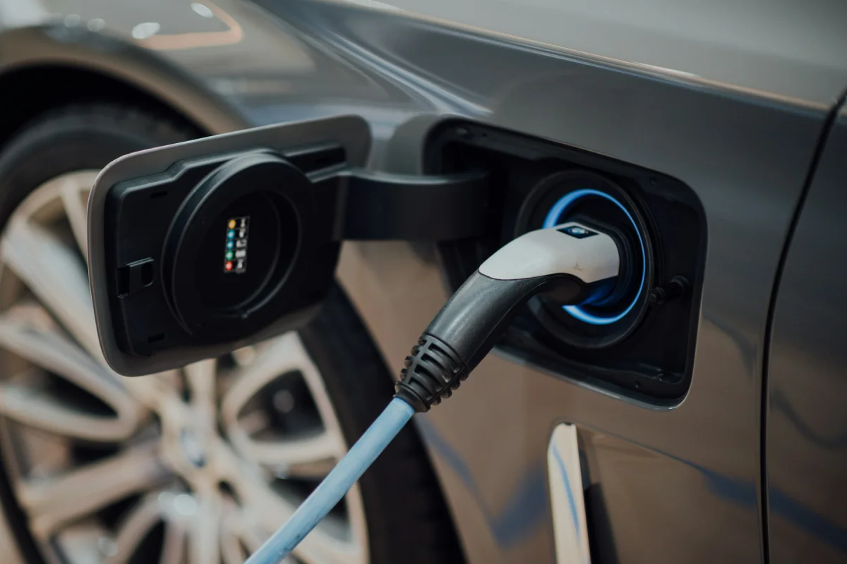 Close-up details of a charging cable securely plugged into a vehicle port after a proper EV charger installation.