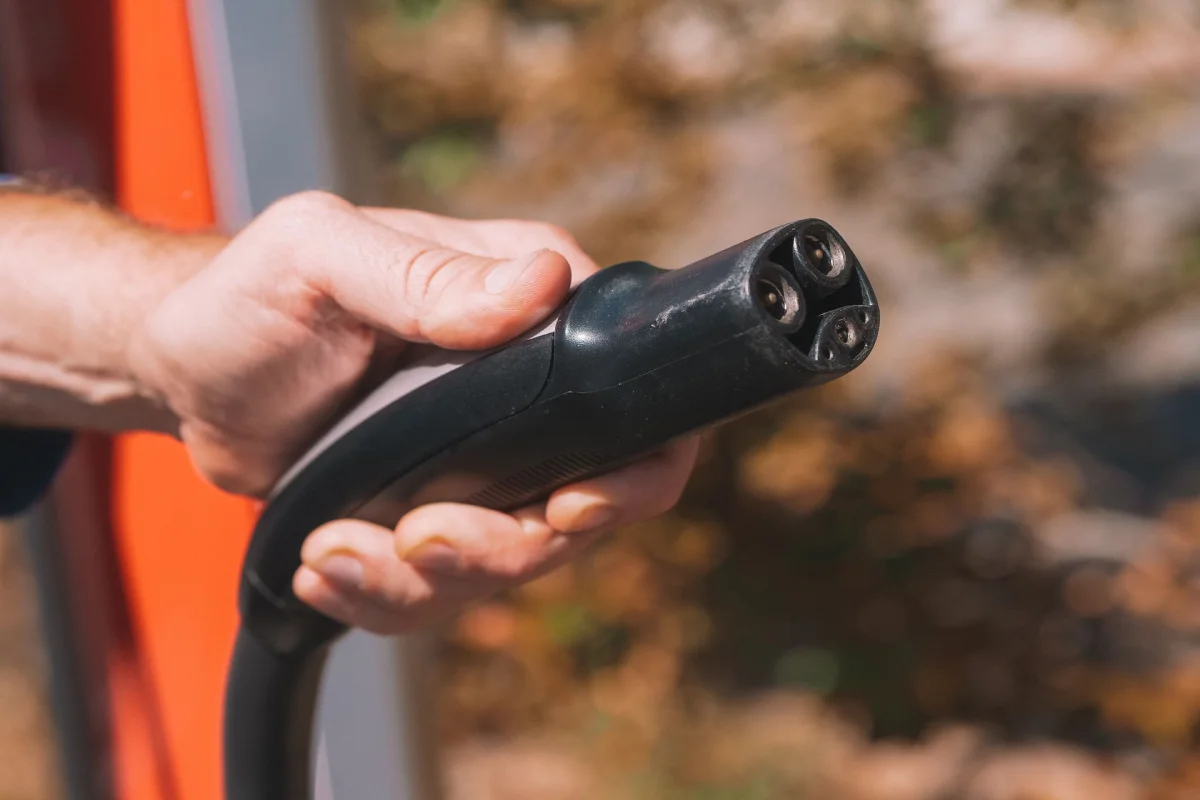 Close-up of electric vehicle charging port showing plug-in connection used in home EV charger installations.